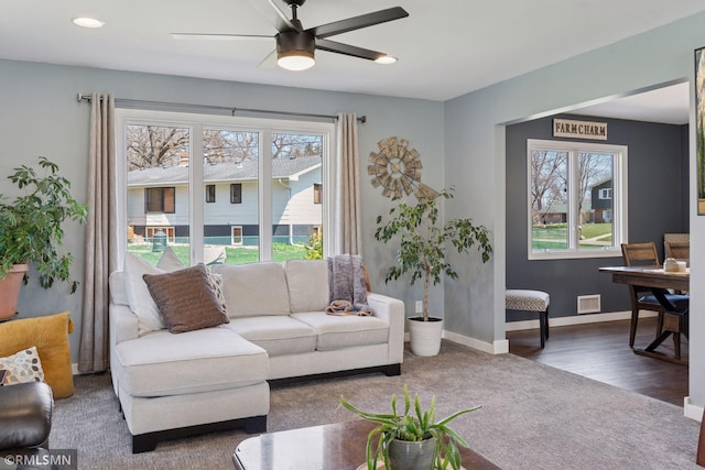 living area with visible vents, carpet floors, baseboards, recessed lighting, and a ceiling fan
