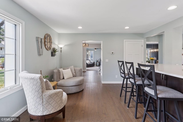 living area with baseboards, recessed lighting, and dark wood finished floors