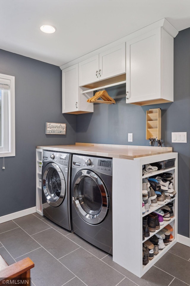 washroom with washing machine and clothes dryer, cabinet space, recessed lighting, baseboards, and dark tile patterned flooring