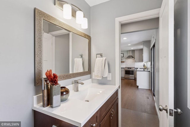 bathroom with vanity, decorative backsplash, and recessed lighting