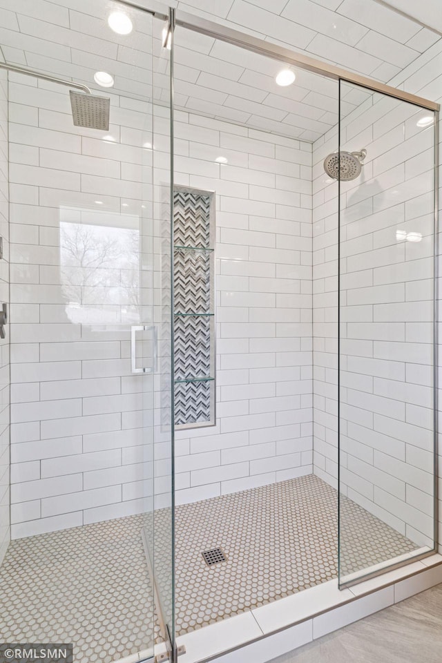 bathroom with recessed lighting and a shower stall