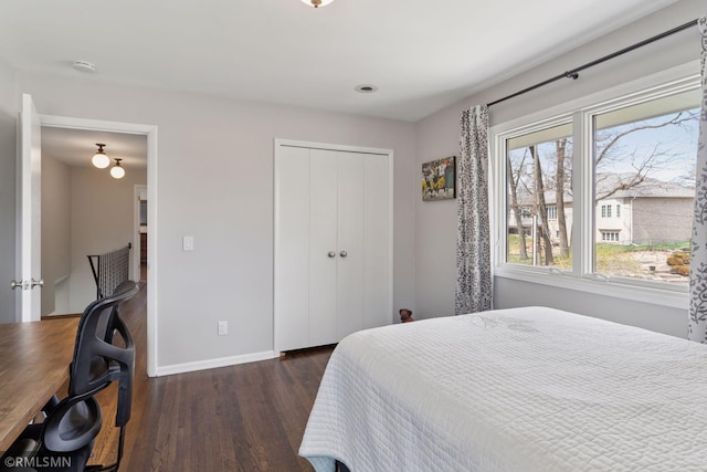 bedroom with baseboards, a closet, and wood finished floors