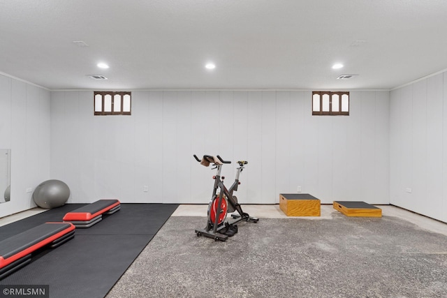 exercise room with a healthy amount of sunlight, recessed lighting, and visible vents
