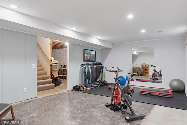 exercise area with visible vents, recessed lighting, and a decorative wall