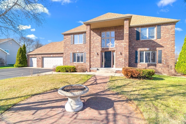 5214 381st Ln, North Branch, MN 55056 - view of front of home with brick siding, aphalt driveway, a front lawn, and an attached garage