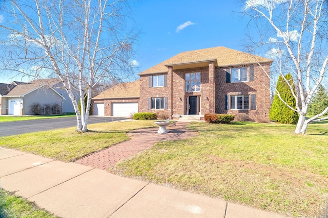 5214 381st Ln, North Branch, MN 55056 - traditional-style house with brick siding, driveway, an attached garage, and a front yard