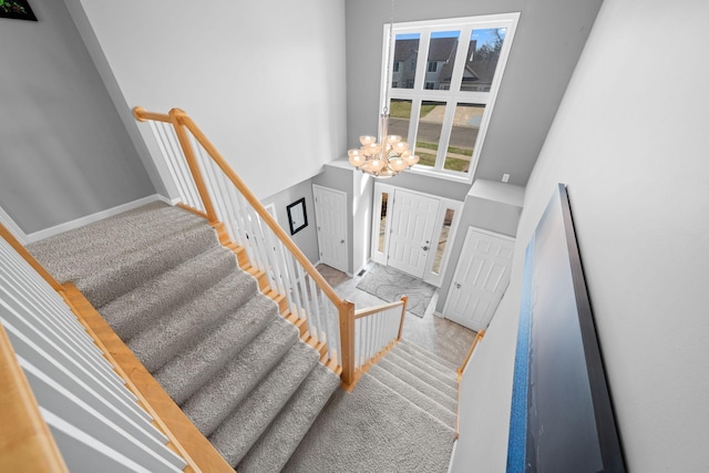 5214 381st Ln, North Branch, MN 55056 - staircase with a towering ceiling, a notable chandelier, and baseboards