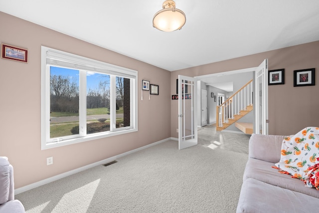 5214 381st Ln, North Branch, MN 55056 - living area with baseboards, stairway, visible vents, and light carpet