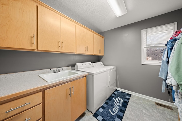 5214 381st Ln, North Branch, MN 55056 - laundry area featuring cabinet space, washing machine and dryer, baseboards, visible vents, and a sink