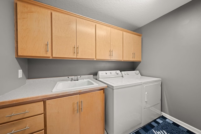 5214 381st Ln, North Branch, MN 55056 - clothes washing area with a sink, cabinet space, a textured ceiling, baseboards, and washer and dryer