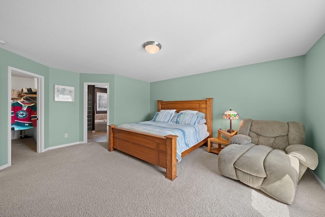 5214 381st Ln, North Branch, MN 55056 - bedroom with baseboards, connected bathroom, a closet, carpet flooring, and a walk in closet