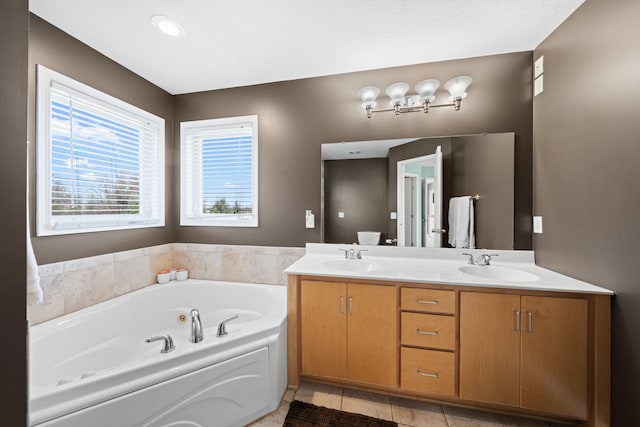 5214 381st Ln, North Branch, MN 55056 - full bathroom with a jetted tub, a sink, double vanity, and tile patterned floors