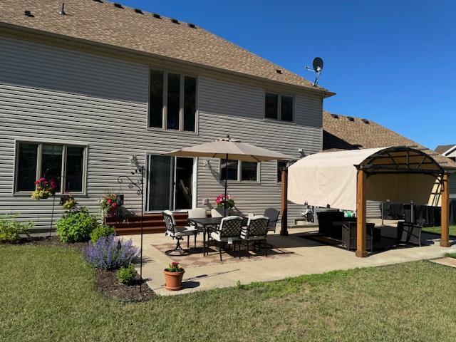5214 381st Ln, North Branch, MN 55056 - back of house with a lawn, an outdoor living space, and a patio area