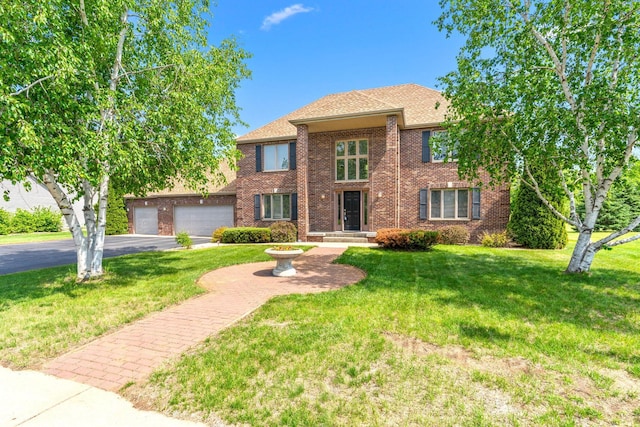 5214 381st Ln, North Branch, MN 55056 - traditional home featuring driveway, a garage, brick siding, and a front yard