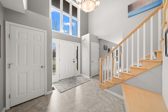 5214 381st Ln, North Branch, MN 55056 - entrance foyer with stairway, a towering ceiling, baseboards, and a chandelier