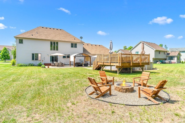 5214 381st Ln, North Branch, MN 55056 - back of house with an outdoor fire pit, a gazebo, a patio, a deck, and a lawn