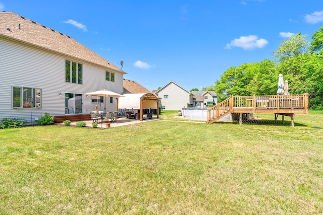 5214 381st Ln, North Branch, MN 55056 - view of green lawn featuring a patio and a deck