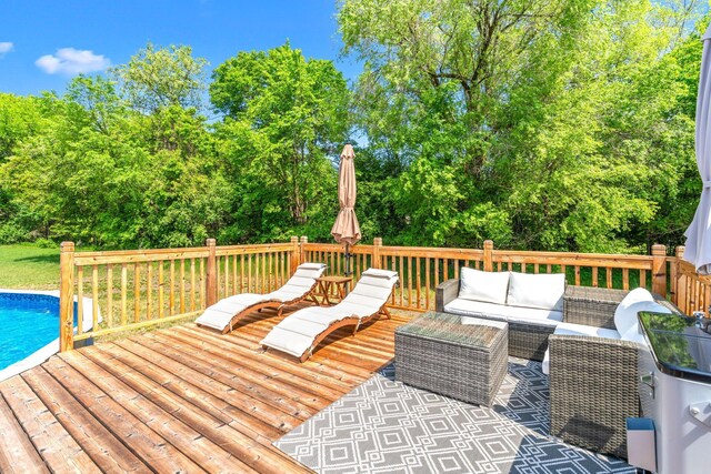 5214 381st Ln, North Branch, MN 55056 - wooden deck with an outdoor living space, an outdoor pool, and view of wooded area
