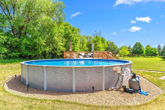 5214 381st Ln, North Branch, MN 55056 - swimming pool featuring a yard, view of scattered trees, and a wooden deck