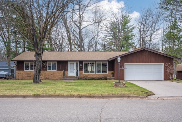 ranch-style home with concrete driveway, stone siding, a shingled roof, a front yard, and an attached garage