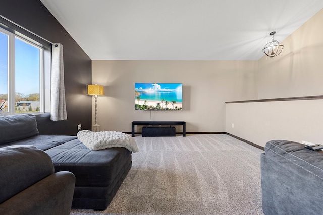 1101 8th Ave SW, Isanti, MN 55040 - carpeted living area featuring baseboards, lofted ceiling, and a chandelier