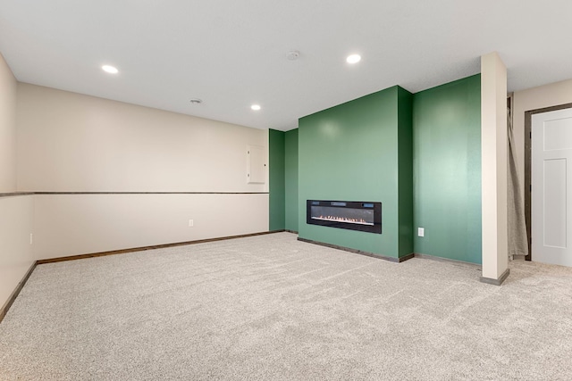 1101 8th Ave SW, Isanti, MN 55040 - unfurnished living room featuring carpet flooring, baseboards, recessed lighting, and a glass covered fireplace