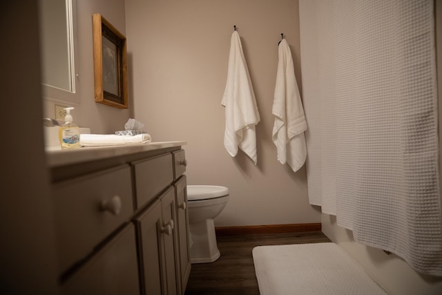 full bathroom featuring vanity, toilet, shower / tub combo, baseboards, and wood finished floors