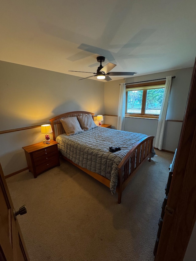 bedroom featuring ceiling fan, baseboards, and carpet floors