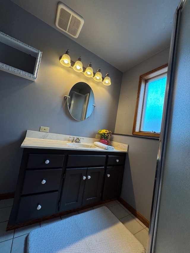 bathroom with visible vents, vanity, tile patterned flooring, and baseboards