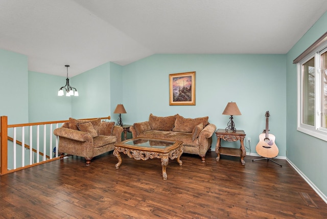 living area with baseboards, vaulted ceiling, wood finished floors, and a notable chandelier