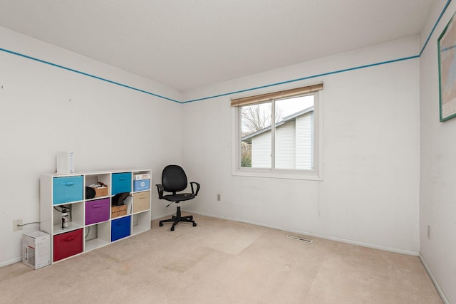 home office with carpet floors, baseboards, and visible vents