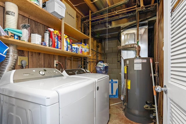 clothes washing area with laundry area, gas water heater, and washing machine and clothes dryer