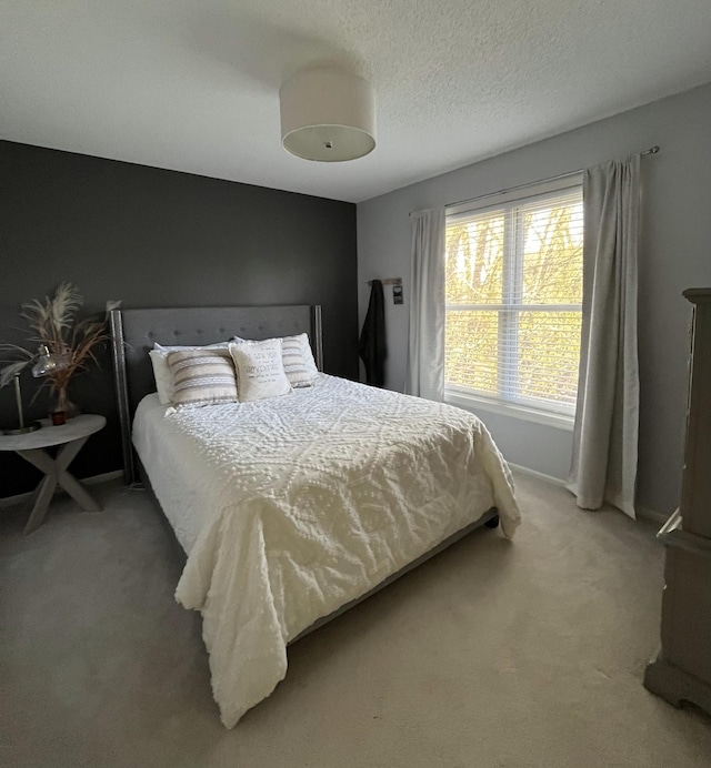 bedroom with light colored carpet and baseboards