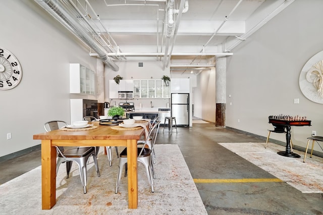 700 Washington Ave N Unit 210, Minneapolis, MN 55401 - dining area featuring finished concrete flooring and baseboards
