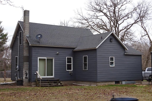 338 40th St, Clear Lake, WI 54005 - rear view of house with a chimney, entry steps, and roof with shingles