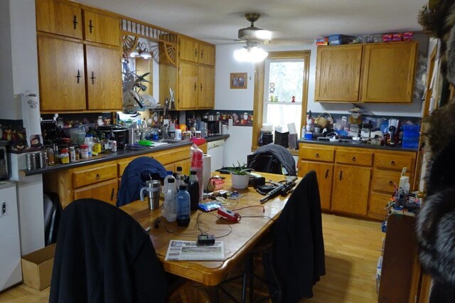 338 40th St, Clear Lake, WI 54005 - kitchen with a sink, light wood finished floors, ceiling fan, and brown cabinetry