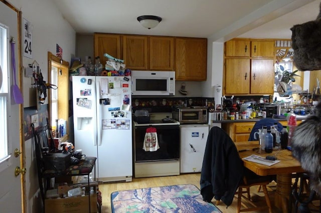 338 40th St, Clear Lake, WI 54005 - kitchen with a toaster, brown cabinets, light wood-style flooring, and white appliances