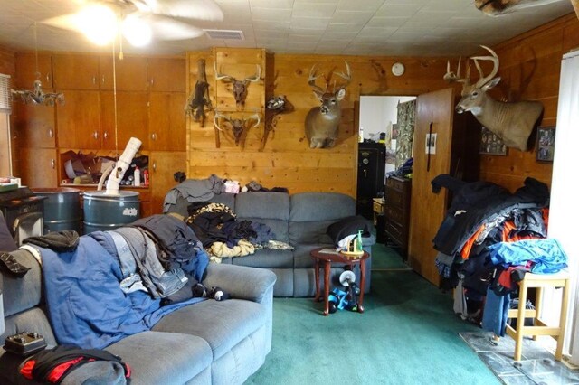 338 40th St, Clear Lake, WI 54005 - living area with carpet, wooden walls, a ceiling fan, and visible vents