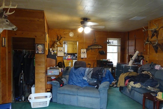 338 40th St, Clear Lake, WI 54005 - living area featuring wood walls, a ceiling fan, and carpet flooring