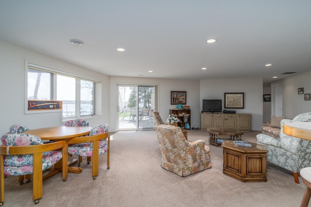 living room featuring recessed lighting, visible vents, and light carpet