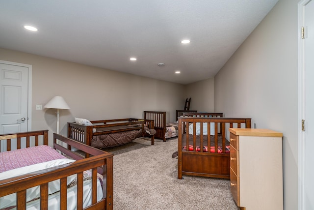 bedroom with light carpet and recessed lighting