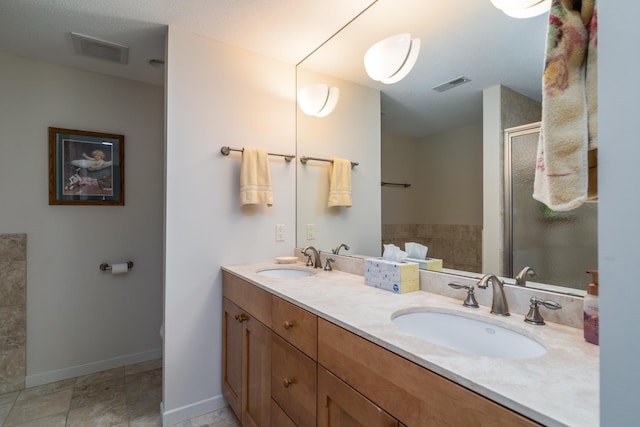 full bath with a sink, a stall shower, and visible vents