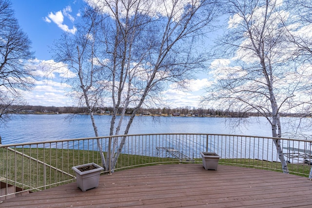 wooden deck featuring a water view and a yard