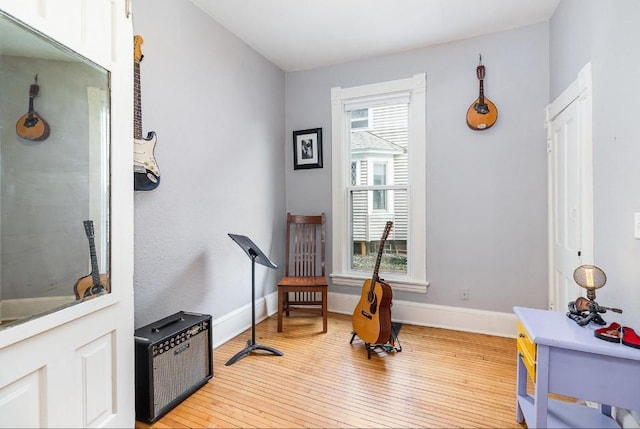2530 Pleasant Ave, Minneapolis, MN 55404 - sitting room featuring baseboards and light wood-type flooring