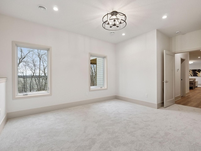 5010 Millie Rd SW, Rochester, MN 55902 - empty room with recessed lighting, baseboards, an inviting chandelier, and carpet