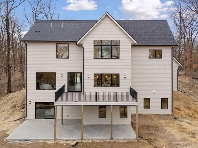 5010 Millie Rd SW, Rochester, MN 55902 - rear view of house featuring roof with shingles and a patio area