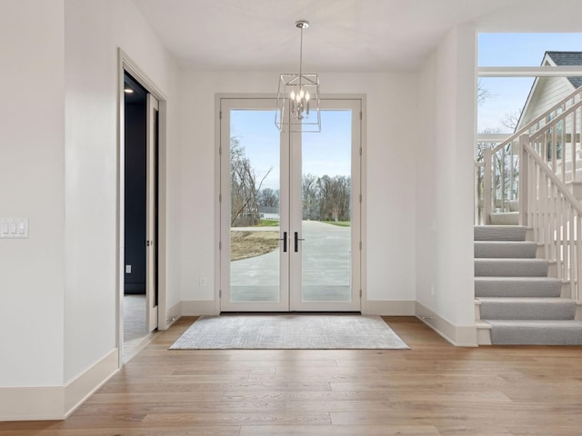 5010 Millie Rd SW, Rochester, MN 55902 - doorway with baseboards, plenty of natural light, and a notable chandelier