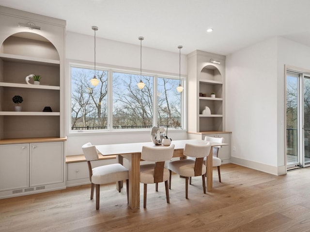 5010 Millie Rd SW, Rochester, MN 55902 - dining area featuring baseboards, visible vents, built in shelves, and light wood-type flooring