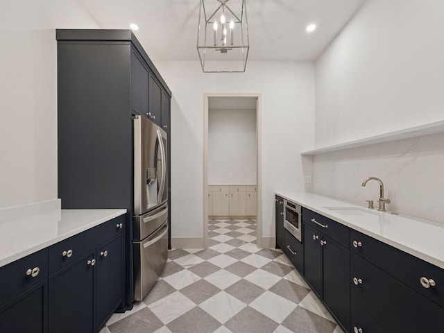 5010 Millie Rd SW, Rochester, MN 55902 - kitchen with a notable chandelier, a sink, stainless steel fridge with ice dispenser, dark cabinets, and recessed lighting