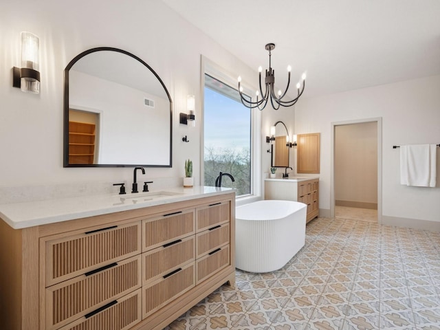 5010 Millie Rd SW, Rochester, MN 55902 - full bathroom featuring visible vents, a sink, a freestanding tub, and a notable chandelier